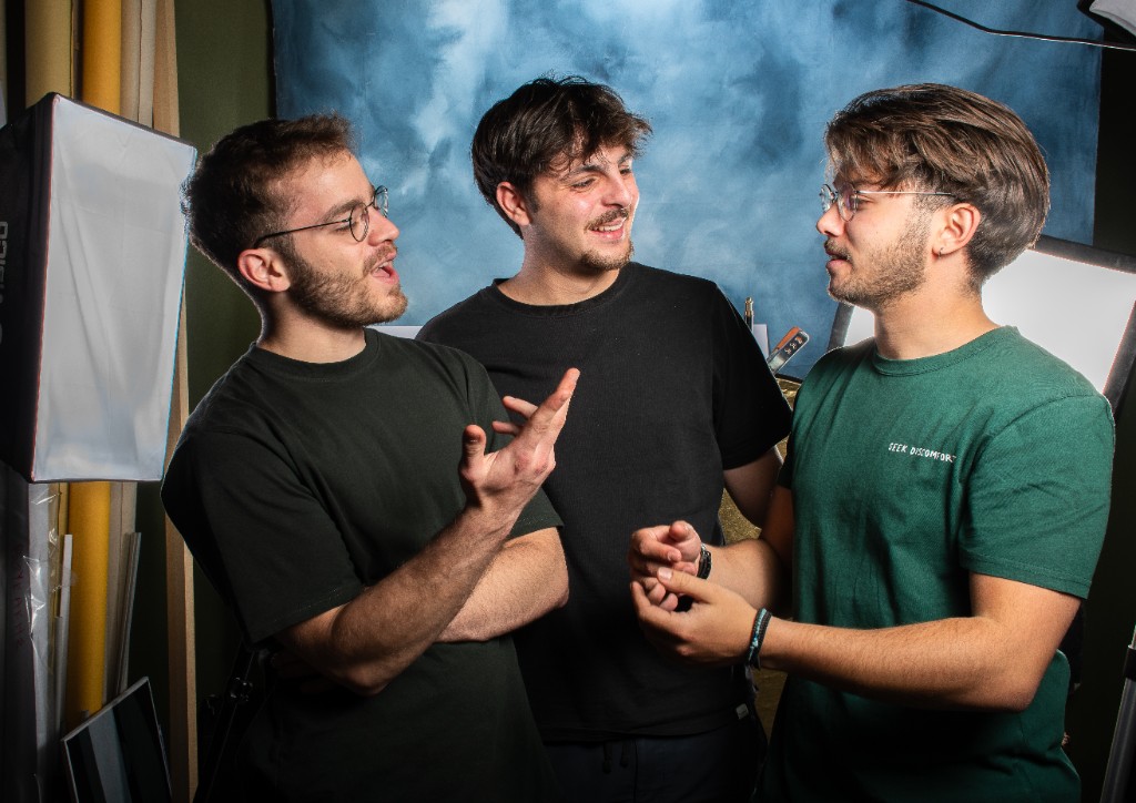 Three team members discussing and collaborating in a photography studio