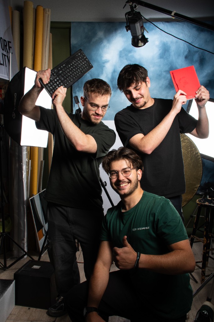Team members in a creative studio setting with props